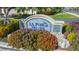 La Puerta Del Sol community sign surrounded by colorful flowers and landscaping at 5825 Puerta Del Sol S Blvd # 170, St Petersburg, FL 33715