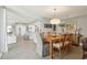 Bright dining room with a wood table, comfortable seating, and an open view to the kitchen area at 5825 Puerta Del Sol S Blvd # 170, St Petersburg, FL 33715