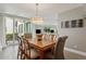 Lovely dining room features a wood table, stylish light fixture, and sliding glass doors to the outside at 5825 Puerta Del Sol S Blvd # 170, St Petersburg, FL 33715