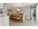 Dining room features a wooden table and chair set, modern light fixtures, and neutral paint at 5825 Puerta Del Sol S Blvd # 170, St Petersburg, FL 33715