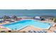 A refreshing pool with comfortable lounge chairs, shaded umbrellas, and a scenic view of the ocean at 5825 Puerta Del Sol S Blvd # 170, St Petersburg, FL 33715