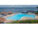 Resort-style pool area features comfortable lounge chairs, tiki huts, and ocean views at 5825 Puerta Del Sol S Blvd # 170, St Petersburg, FL 33715