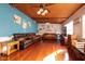 Relaxing living room featuring hardwood floors, a wood-paneled ceiling, and comfortable leather sofas at 809 41St N Ave, St Petersburg, FL 33703