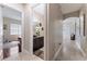 Well-lit hallway with views into a bedroom and bathroom at 13102 Done Groven Dr, Dover, FL 33527