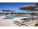 View of a resort-style pool and deck with lounge chairs and umbrellas at 31454 Woodland Race Loop, Wesley Chapel, FL 33545