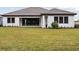 The home's backyard features lush green grass and a large sliding glass door for indoor/outdoor living at 12823 Daleridge Pl, Riverview, FL 33579