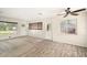 Bright living room with wood-look floors and large windows at 6611 14Th N St, St Petersburg, FL 33702