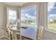 Dining area with table and chairs overlooking tennis courts at 8246 Aquila St, Port Richey, FL 34668