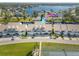 Beautiful aerial view of coastal townhomes boasting water access, a tennis court, and lush green lawns at 8246 Aquila St, Port Richey, FL 34668