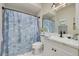 Well-maintained bathroom featuring a single sink vanity and a shower with decorative curtain at 8246 Aquila St, Port Richey, FL 34668