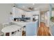 Well-lit kitchen with modern white cabinetry, stainless steel appliances, and breakfast bar with seating at 8246 Aquila St, Port Richey, FL 34668