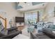 Bright living room featuring stylish furniture, balcony access, and plenty of natural light at 8246 Aquila St, Port Richey, FL 34668