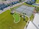 Aerial view of community tennis courts, putting green, and lush landscaping at 8246 Aquila St, Port Richey, FL 34668