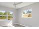 Bright bedroom with two windows, ceiling fan, and light grey walls at 6614 10Th Avenue S Ter, St Petersburg, FL 33707