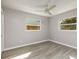 Simple bedroom with ceiling fan, grey walls, and wood-look flooring at 6614 10Th Avenue S Ter, St Petersburg, FL 33707