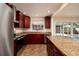Updated kitchen with granite counters, stainless steel appliances, and wood cabinets at 6614 10Th Avenue S Ter, St Petersburg, FL 33707
