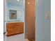 Updated bathroom with light blue walls, wood vanity, and walk-in shower at 6614 10Th Avenue S Ter, St Petersburg, FL 33707
