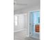 Bedroom with light grey walls, wood-look flooring and access to bathroom at 6614 10Th Avenue S Ter, St Petersburg, FL 33707