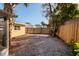 Backyard with gravel and screened porch at 6614 10Th Avenue S Ter, St Petersburg, FL 33707