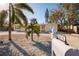 Cute yellow house with palm trees, and a rock driveway at 6614 10Th Avenue S Ter, St Petersburg, FL 33707