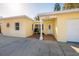 Bright yellow house with white door and garage, featuring a sun design at 6614 10Th Avenue S Ter, St Petersburg, FL 33707