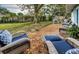 Relaxing backyard patio with wicker chairs and gravel at 1480 Sunset Point Rd, Clearwater, FL 33755