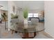 Bright dining room with glass table and four gray chairs, overlooking living room at 217 Lake Tarpon Dr # 24, Palm Harbor, FL 34684