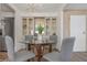 Modern dining area with glass-top table and four gray chairs at 217 Lake Tarpon Dr # 24, Palm Harbor, FL 34684