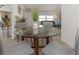 View of a contemporary dining area with a round glass table and gray chairs at 217 Lake Tarpon Dr # 24, Palm Harbor, FL 34684