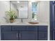 Stylish bathroom with navy blue vanity and white countertop at 217 Lake Tarpon Dr # 24, Palm Harbor, FL 34684