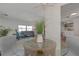 Modern dining room features a glass-top table and gray chairs, open to living area at 217 Lake Tarpon Dr # 24, Palm Harbor, FL 34684