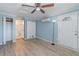 Light blue bedroom with wood-look floors and built-in closet at 425 Treasure Rd, Venice, FL 34293