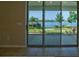 View from patio sliding doors, with lake and backyard flower garden at 1027 Ocean Spray Dr, Ruskin, FL 33570