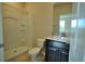 Well-lit bathroom boasts a modern vanity, framed mirror, and a shower-tub combination at 1027 Ocean Spray Dr, Ruskin, FL 33570