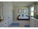 Bright bedroom with white dressers and a day bed at 1027 Ocean Spray Dr, Ruskin, FL 33570