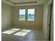 Bedroom with two windows letting in plenty of natural light over ceramic tile flooring at 1027 Ocean Spray Dr, Ruskin, FL 33570