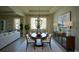Staged dining room with chandelier, dining table, sideboard, and curtains at 1027 Ocean Spray Dr, Ruskin, FL 33570
