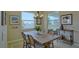 Staged dining room with lake views, stylish decor, and plenty of natural light at 1027 Ocean Spray Dr, Ruskin, FL 33570