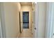 Hallway leading to garage access, with ceramic tile flooring, and neutral walls at 1027 Ocean Spray Dr, Ruskin, FL 33570
