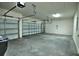 Spacious three car garage featuring concrete floors and white walls at 1027 Ocean Spray Dr, Ruskin, FL 33570