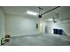 Spacious garage features concrete floors and access to an adjacent storage area at 1027 Ocean Spray Dr, Ruskin, FL 33570