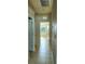 Hallway with tiled floors, showing entry into a bedroom and bathroom at 1027 Ocean Spray Dr, Ruskin, FL 33570