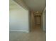 Clean hallway with tile floors leading to the front door at 1027 Ocean Spray Dr, Ruskin, FL 33570