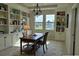 Home office with custom built-in shelving, desk and large windows overlooking the landscaped yard at 1027 Ocean Spray Dr, Ruskin, FL 33570