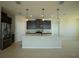 Modern kitchen with dark cabinetry, stainless steel appliances, and granite countertops at 1027 Ocean Spray Dr, Ruskin, FL 33570
