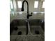 Close-up of kitchen sink with granite countertops and modern faucet in a bright, open space at 1027 Ocean Spray Dr, Ruskin, FL 33570