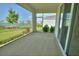 Covered lanai overlooking a picturesque lake with lush landscaping and a serene outdoor view at 1027 Ocean Spray Dr, Ruskin, FL 33570