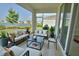 Furnished lanai offers relaxing lake views, featuring comfortable seating and stylish decor at 1027 Ocean Spray Dr, Ruskin, FL 33570
