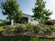 Beautifully landscaped backyard featuring trees, pink flowers and decorative rock surrounding the home at 1027 Ocean Spray Dr, Ruskin, FL 33570