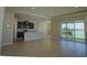Open-concept kitchen and living area with breakfast bar and lake view at 1027 Ocean Spray Dr, Ruskin, FL 33570